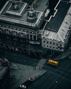 Aerial city view showcasing a bustling urban intersection with a prominent yellow bus.