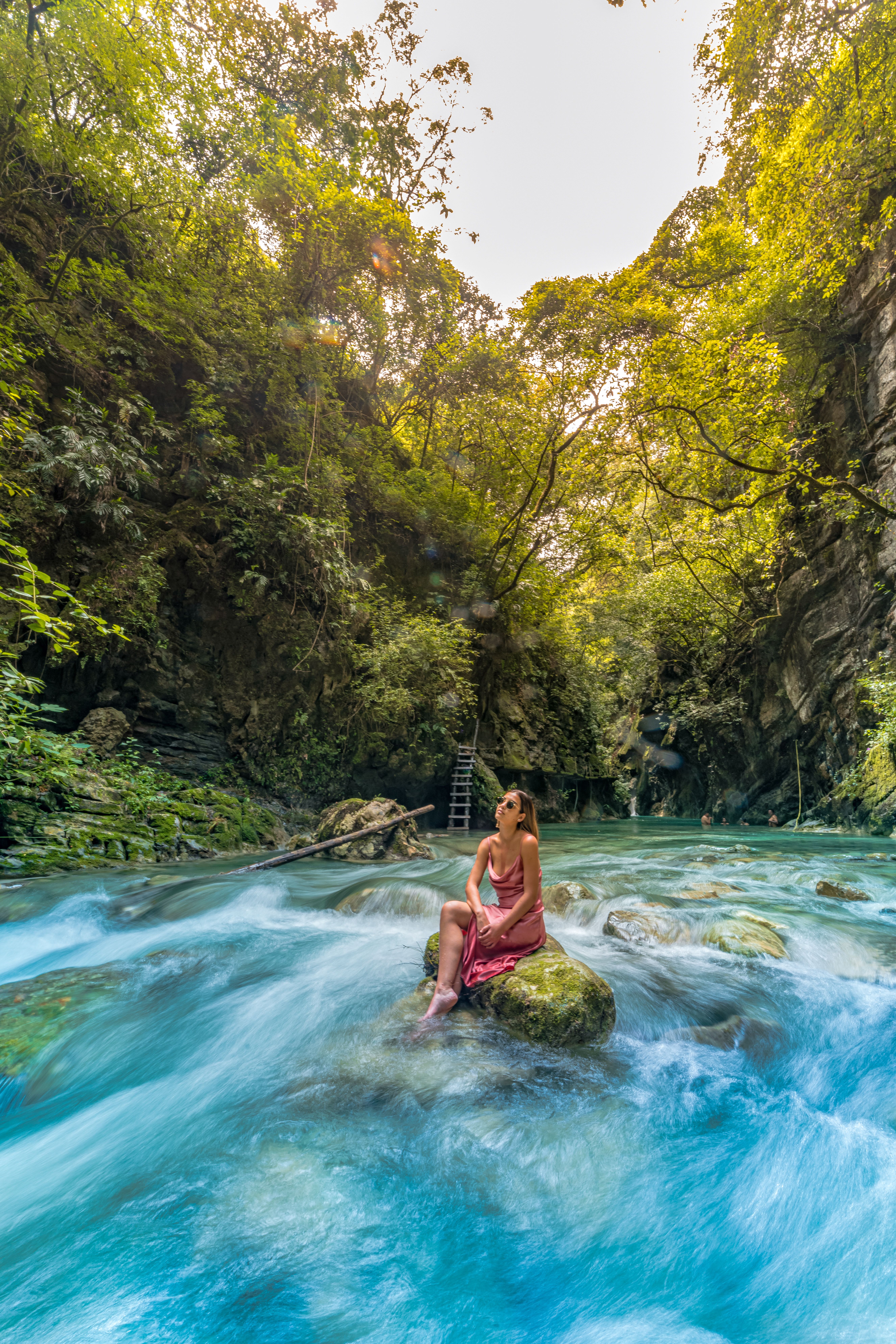 Woman in Pink Dress Sitting on a Rock · Free Stock Photo