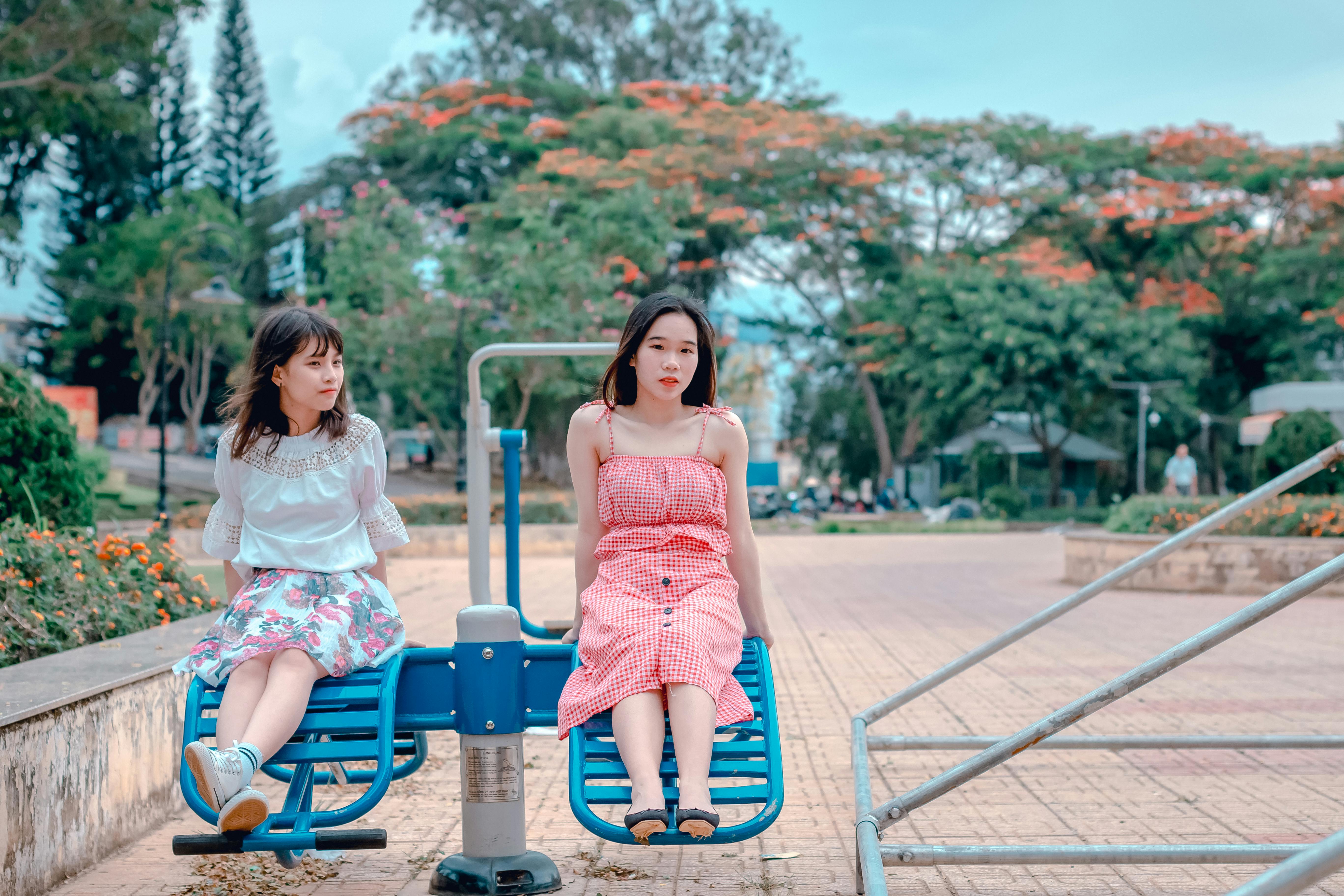 two woman sitting at park ride