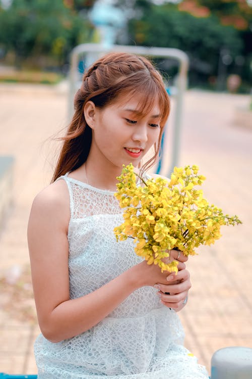 Free Woman Holding Yellow Petaled Flower Bouquet Stock Photo