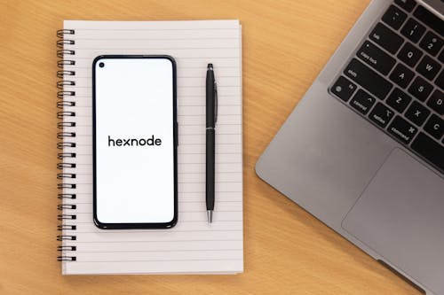 Free A Smartphone and a Pen on a Notebook Stock Photo