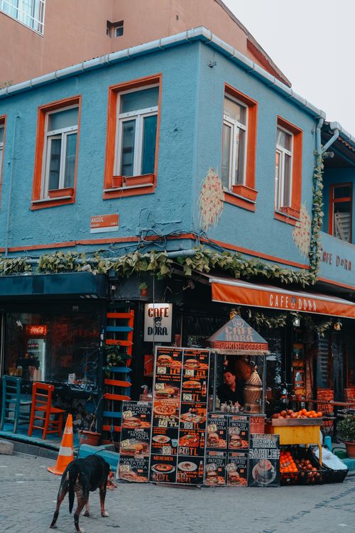 Free A colorful street corner featuring a vibrant café exterior with a lively urban setting. Stock Photo