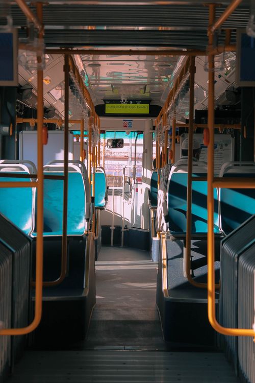 Free Interior shot of an empty public bus in Karachi, highlighting vibrant seats and modern design. Stock Photo