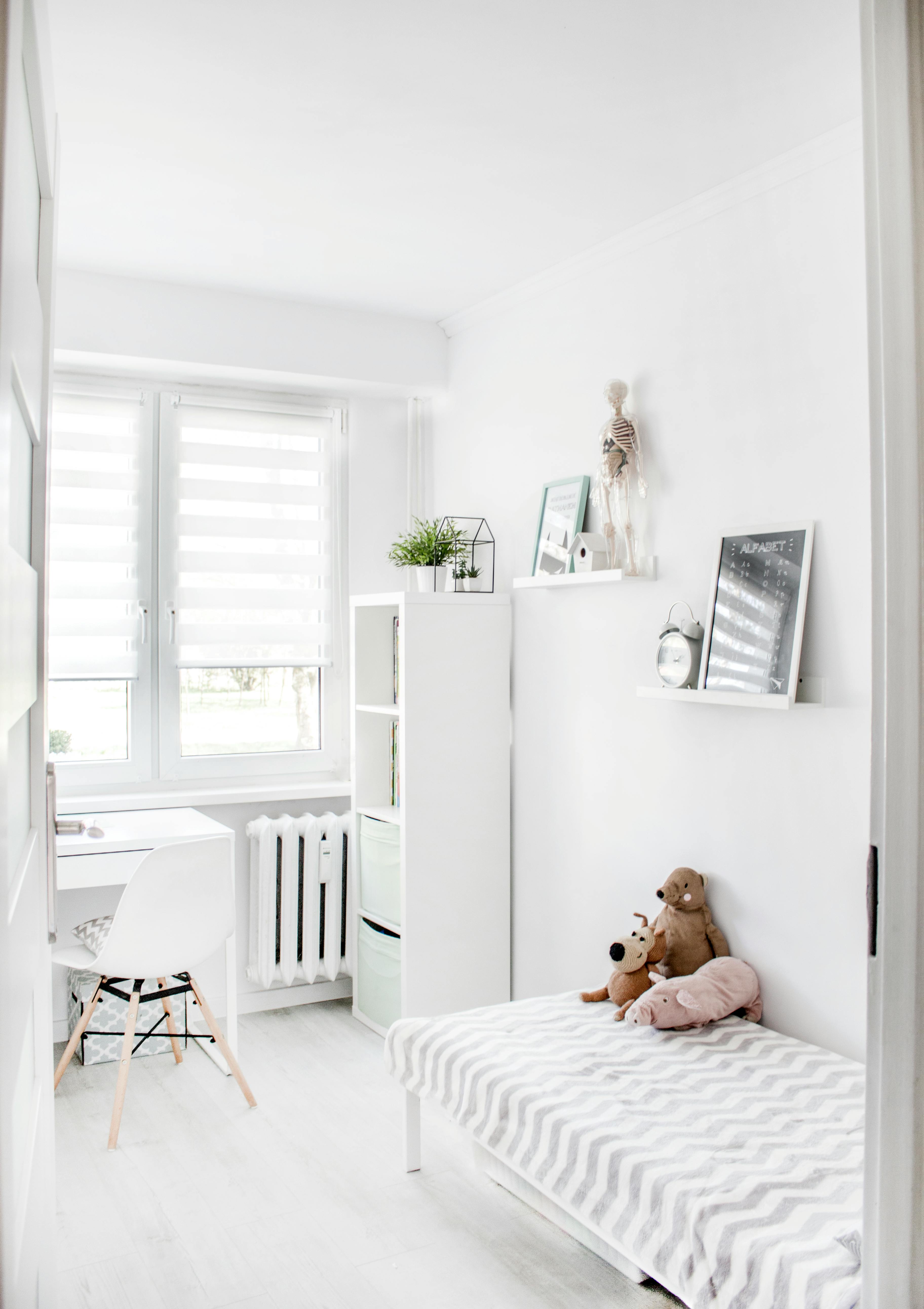 plush toys on top of white and grey mattress inside bedroom