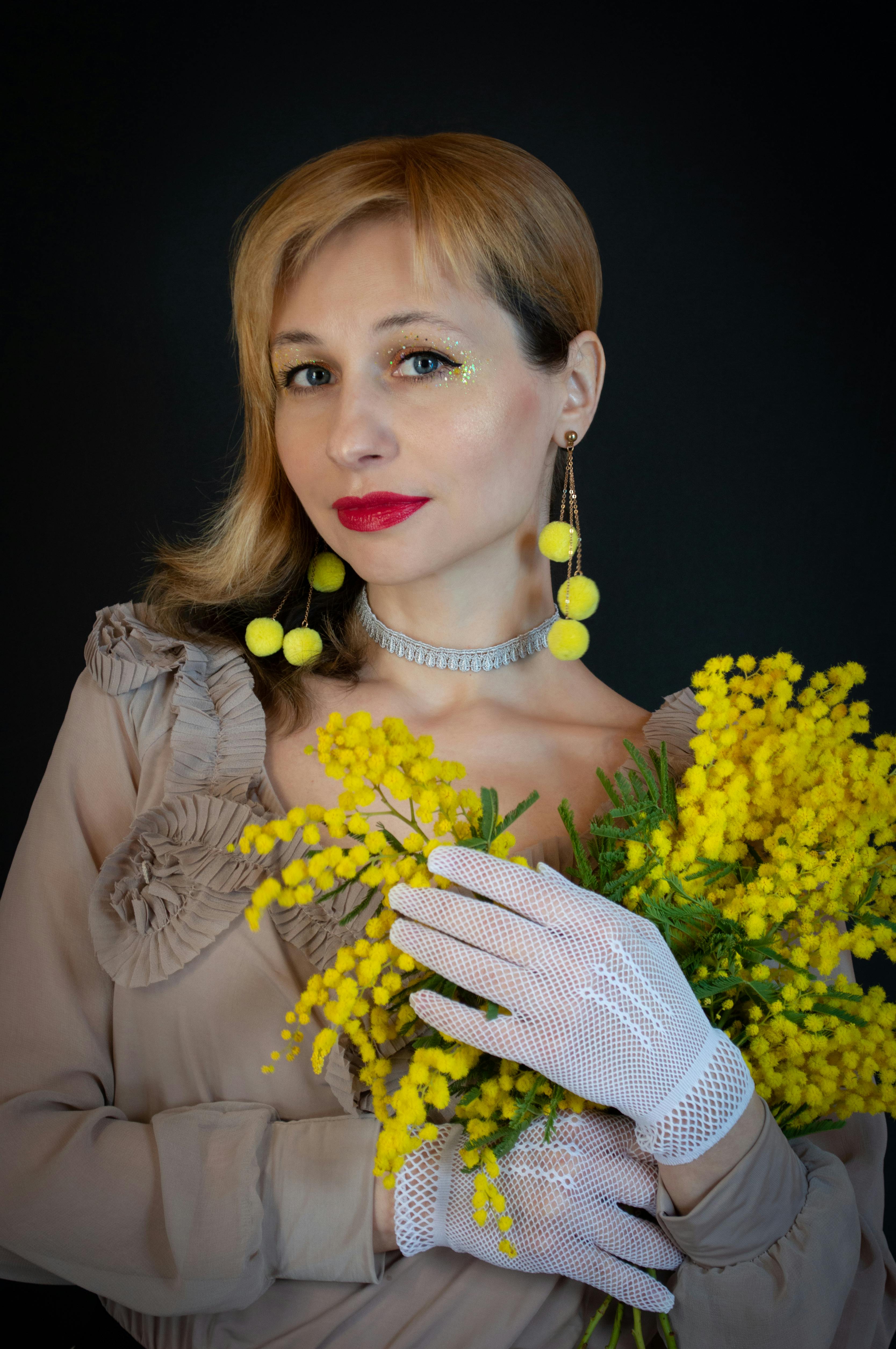 A Woman Carrying Yellow Flowers · Free Stock Photo