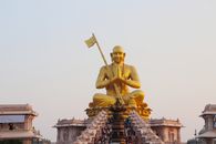 Gold Statue of Man Holding Flag