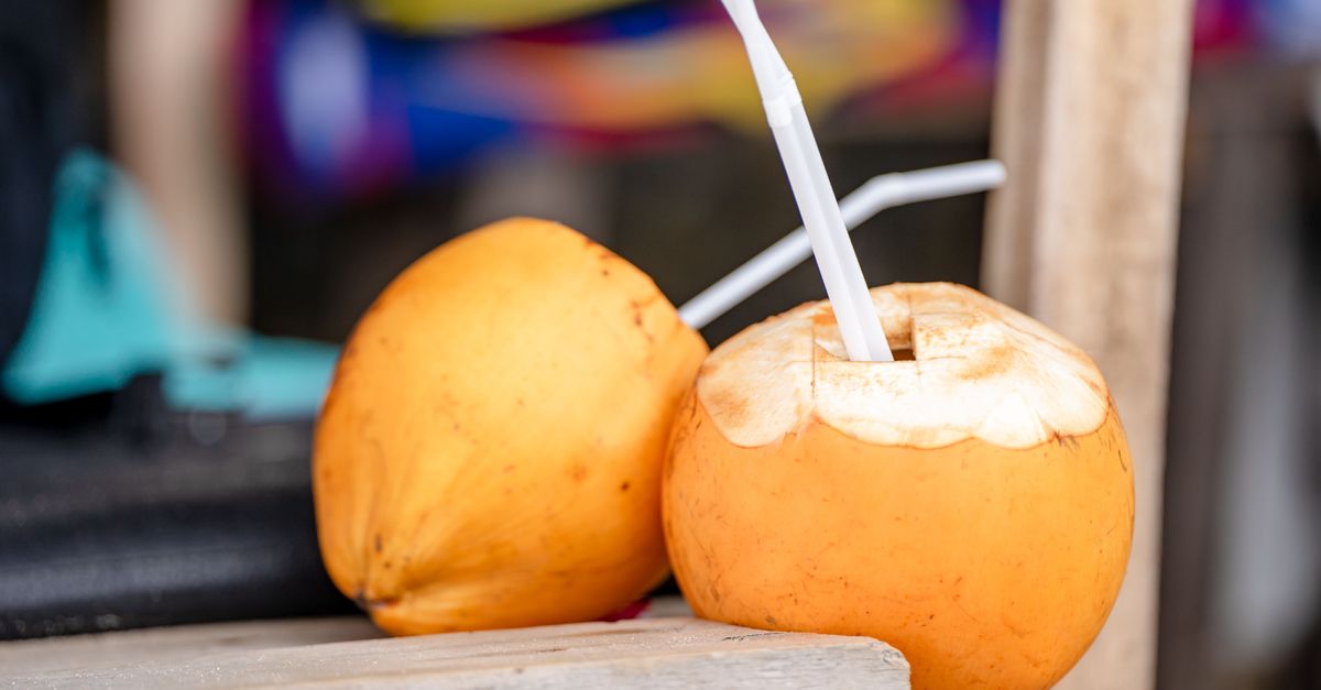 Close-up of fresh yellow coconuts with drinking straws, perfect for a tropical refreshment. - Evidence evidence guide for coconut water exercise hydration randomized trial