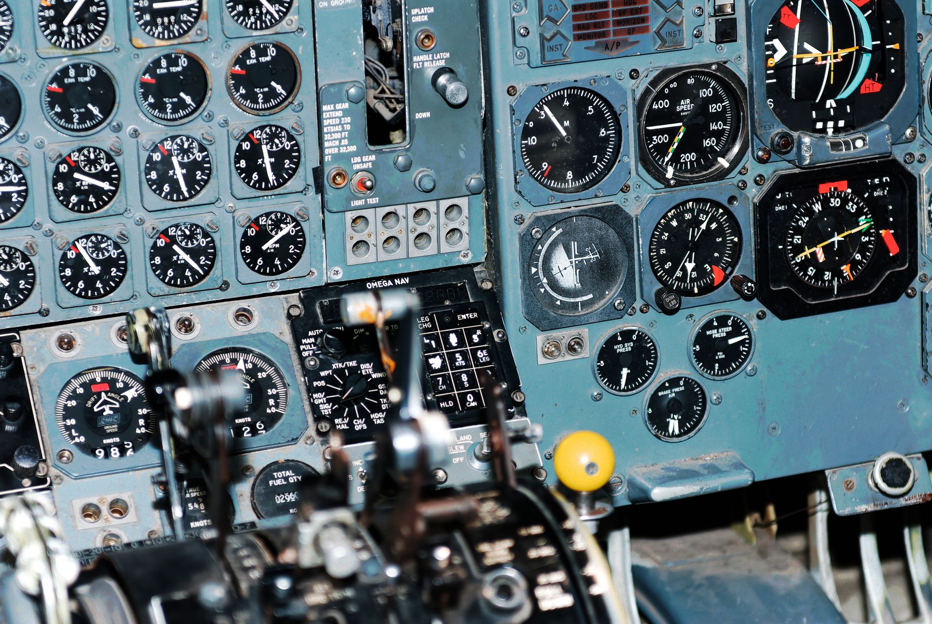 Close-up photo of an aircraft cockpit showcasing various aviation control panels and instruments.