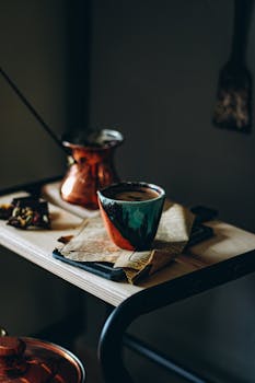 Colorful cup of coffee on a table with a newspaper, creating a warm and cozy atmosphere.