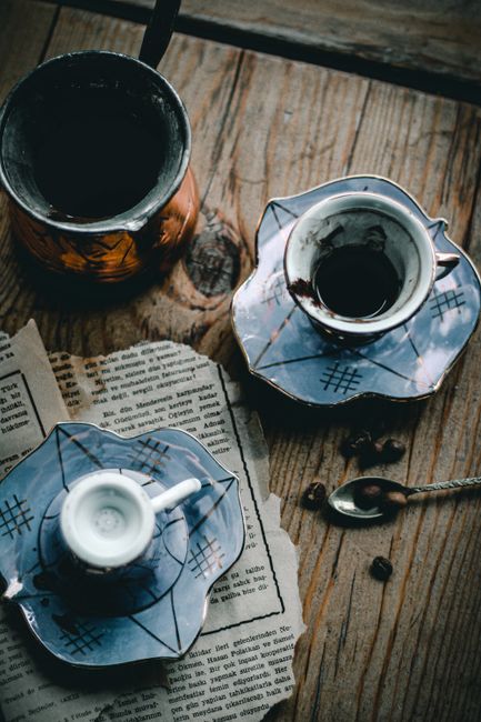 Elegantly arranged Turkish coffee cups and accessories on a rustic wooden table.