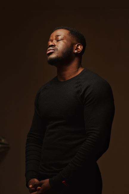 Portrait of a thoughtful African American man with closed eyes, wearing a black sweater. Portrait of a thoughtful African American man with closed eyes, wearing a black sweater.
