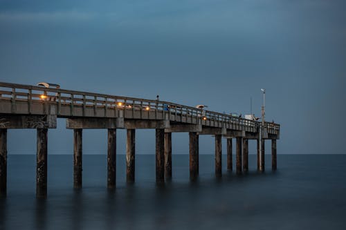 Free A Pier on Body of Water Under Blue Sky Stock Photo