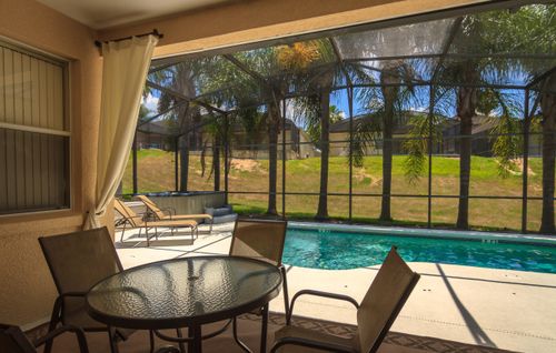 Free stock photo of palm trees and pool, pool, pool with covered lanai Stock Photo