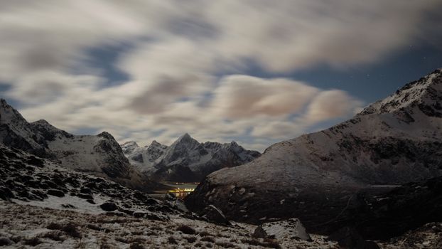 A breathtaking view of snow-capped mountains under a dynamic twilight sky, perfect for nature enthusiasts.
