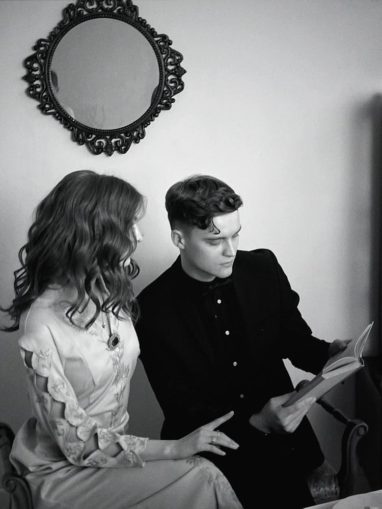Man And Woman Looking At A Book
