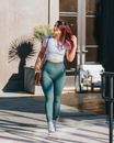 Woman in White Tank Top and Green Leggings Walking