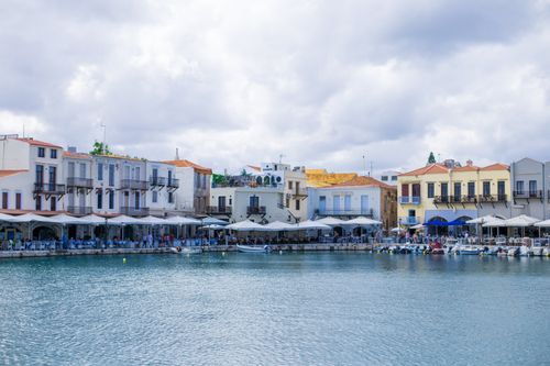 Free Charming waterfront with colorful buildings and peaceful harbor in Rethymno, Greece. Stock Photo