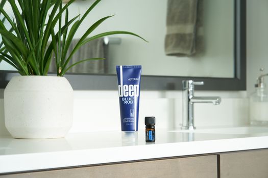 Blue and White Plastic Tube Bottle on White Ceramic Sink