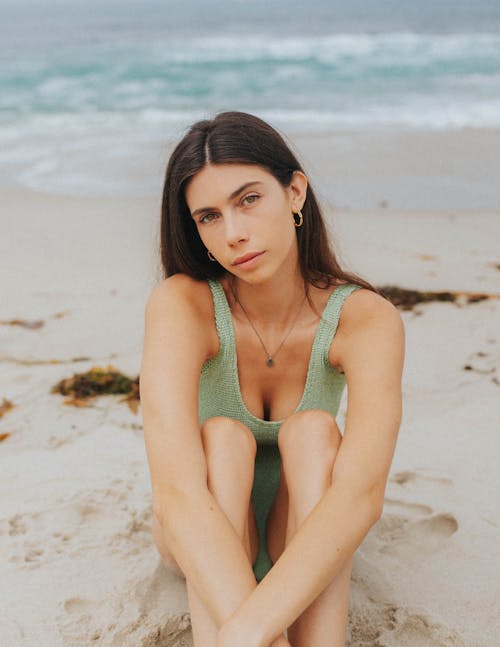 Brunette Woman in Swimsuit Sitting on Beach 