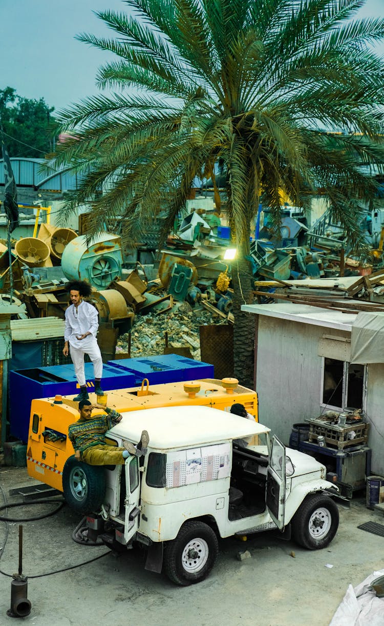 Containers And White Jeep At Junkyard