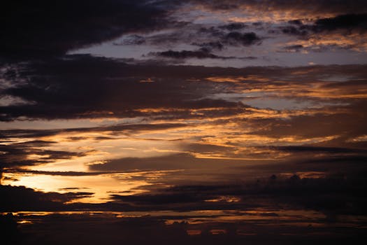 A stunning capture of a dramatic sunset with clouds illuminated by the evening light, creating a breathtaking view.