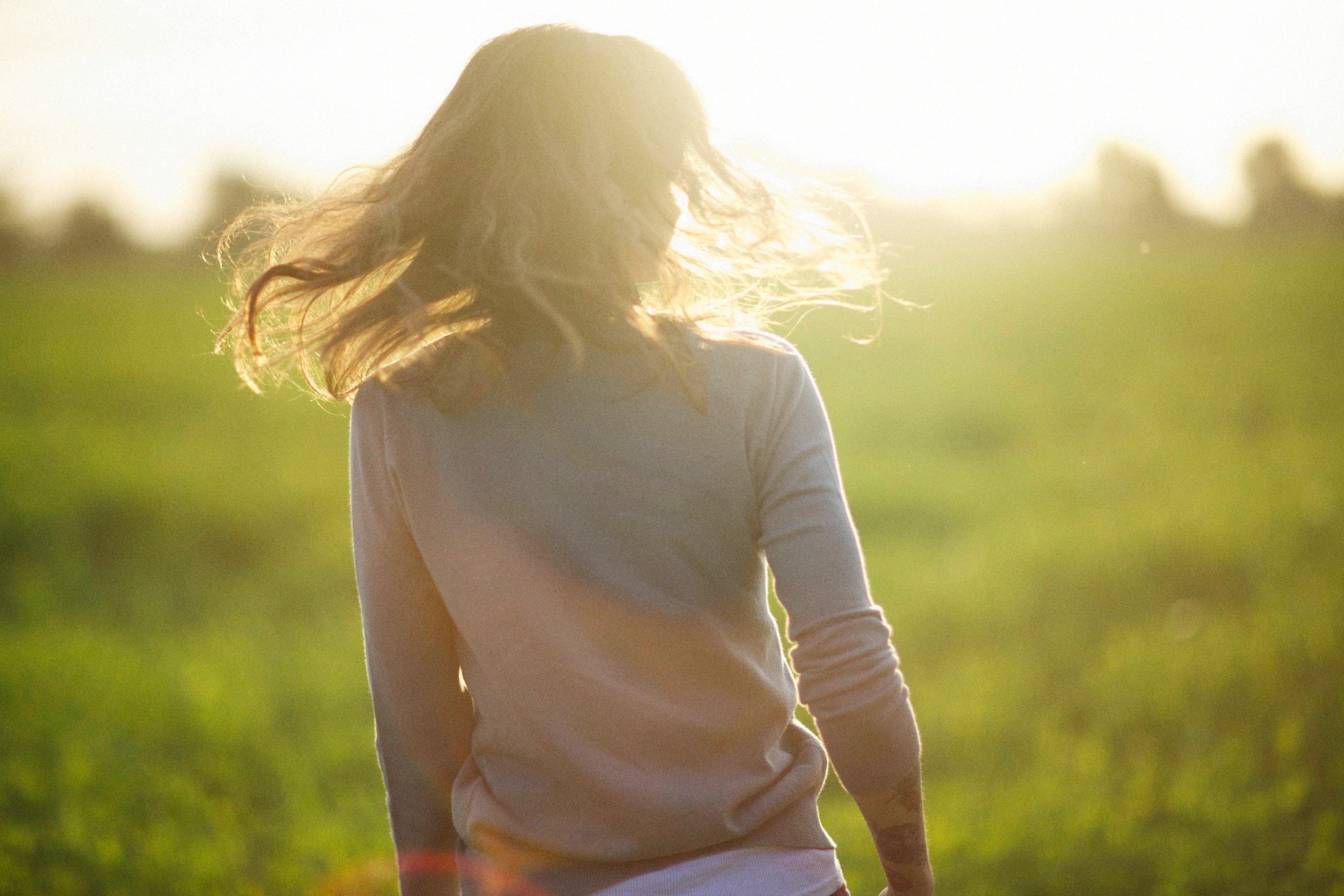 Woman in Pink Long Sleeves on a Grass Field · Free Stock Photo