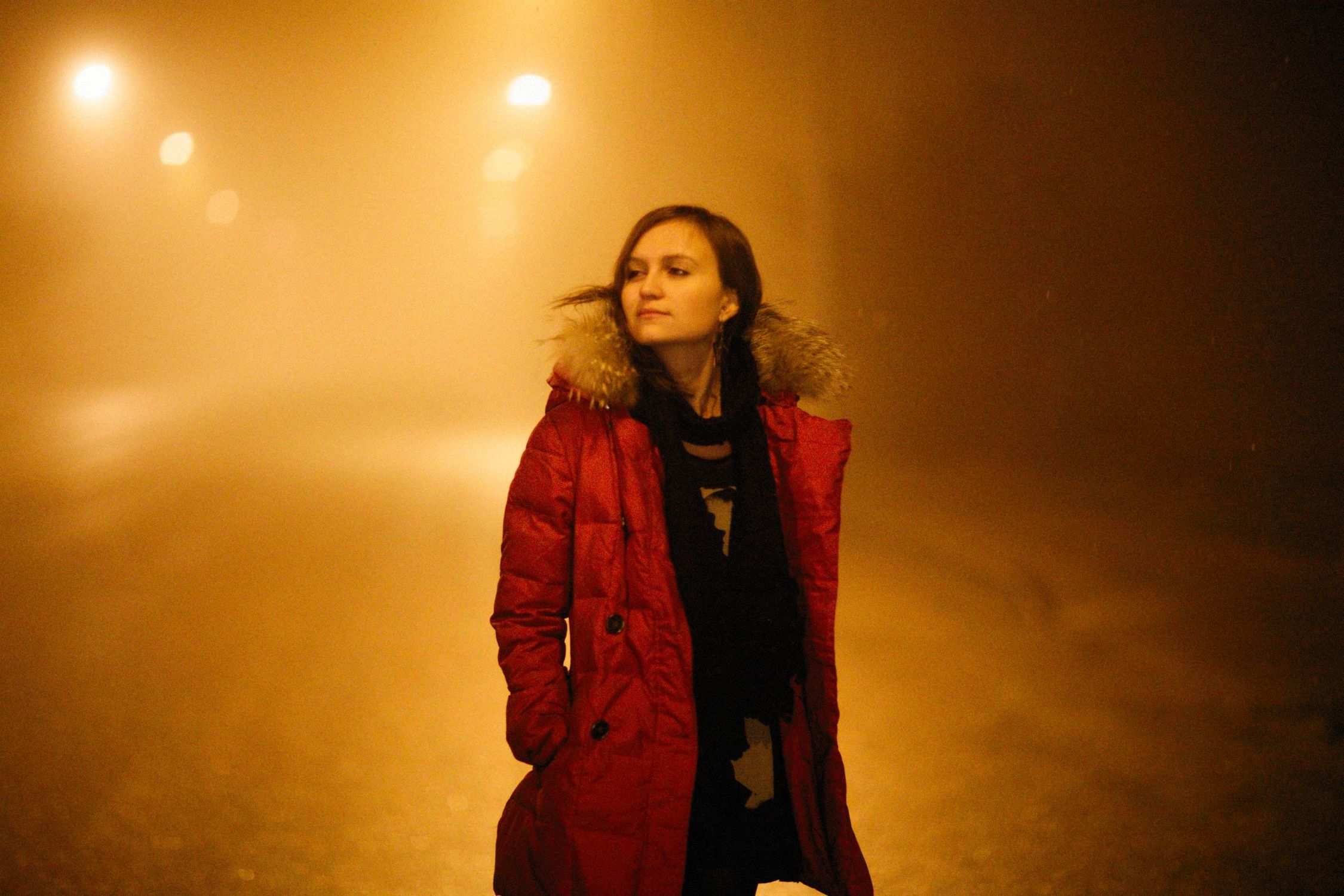 Woman in Red Coat Walking on a Foggy Street · Free Stock Photo
