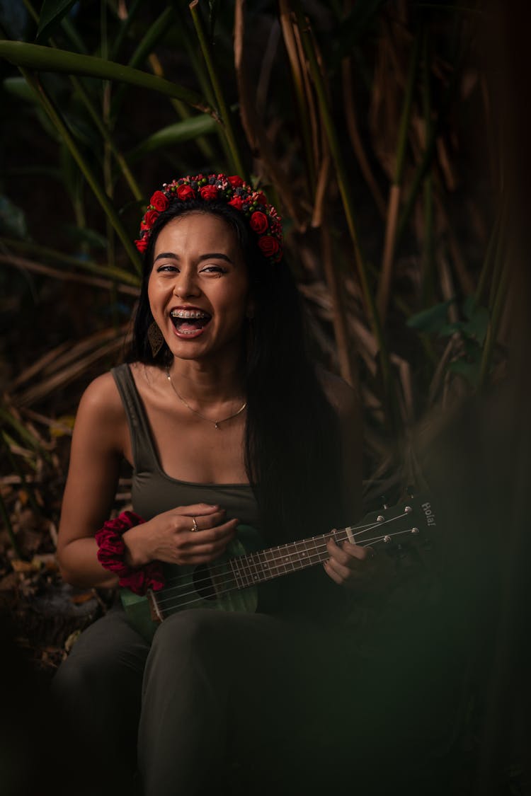 Woman In Tank Top Playing Ukelele