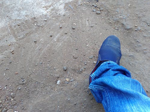 Free stock photo of blue jeans, mud, road