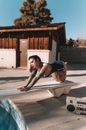 A Woman with Tattoos Posing on a Diving Board