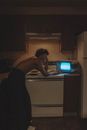 Man in Black Tank Top Standing in Front of White Microwave Oven