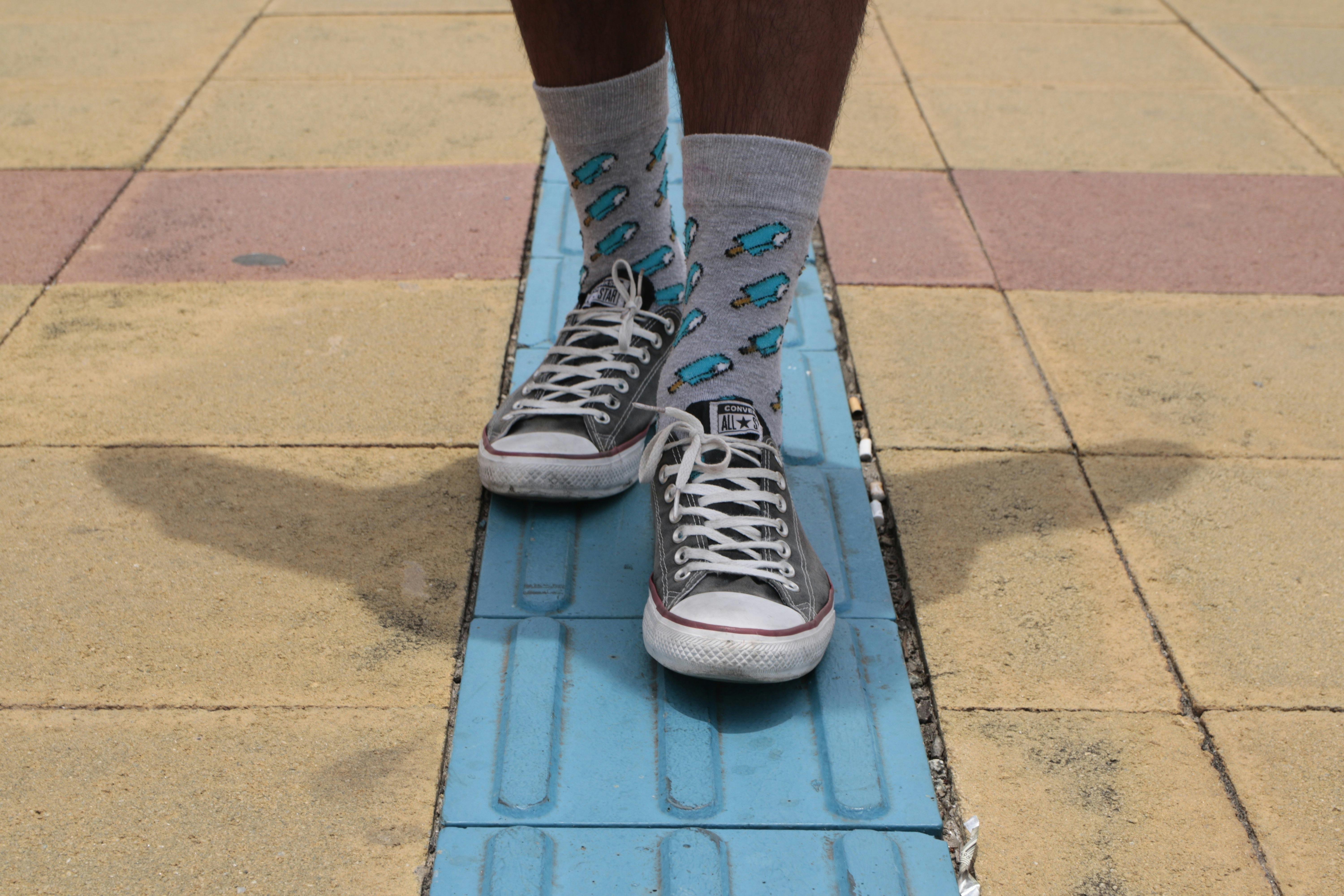 Person Wearing Converse Shoes and Gray Socks · Free Stock Photo