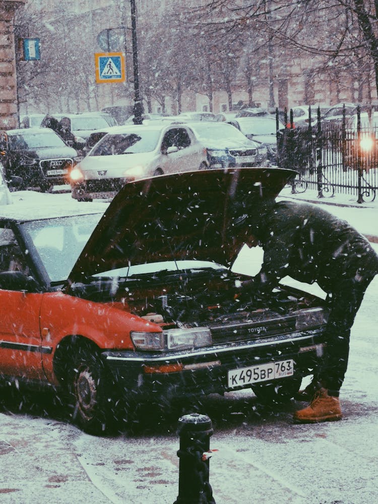 A Man Fixing The Car 