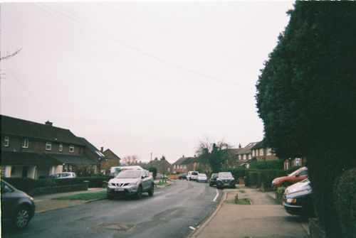 Free A quiet residential street in St Albans, England showcasing parked cars and houses. Stock Photo