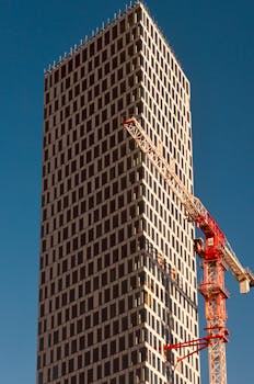 High-rise building with crane in Gothenburg under a clear blue sky.
