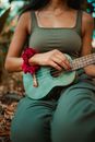 Woman in Gray Tank Top Playing Acoustic Guitar