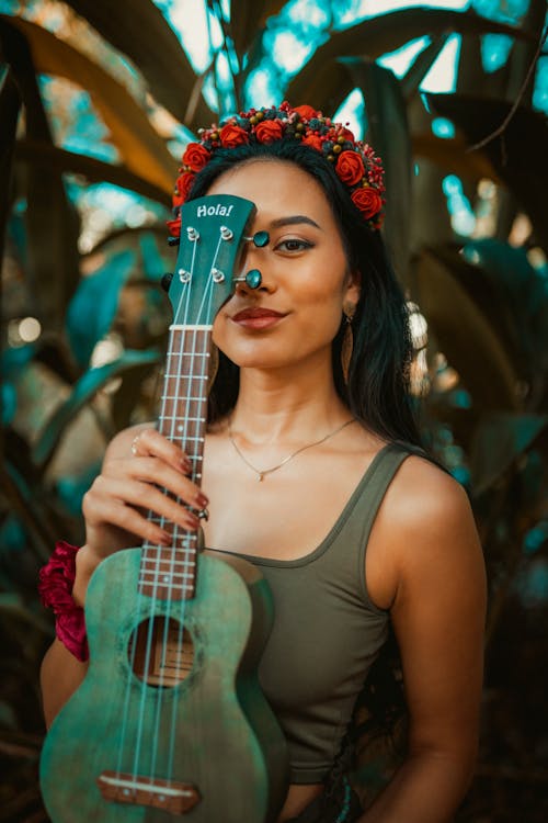 Woman in Green Tank Top Covering Her Face