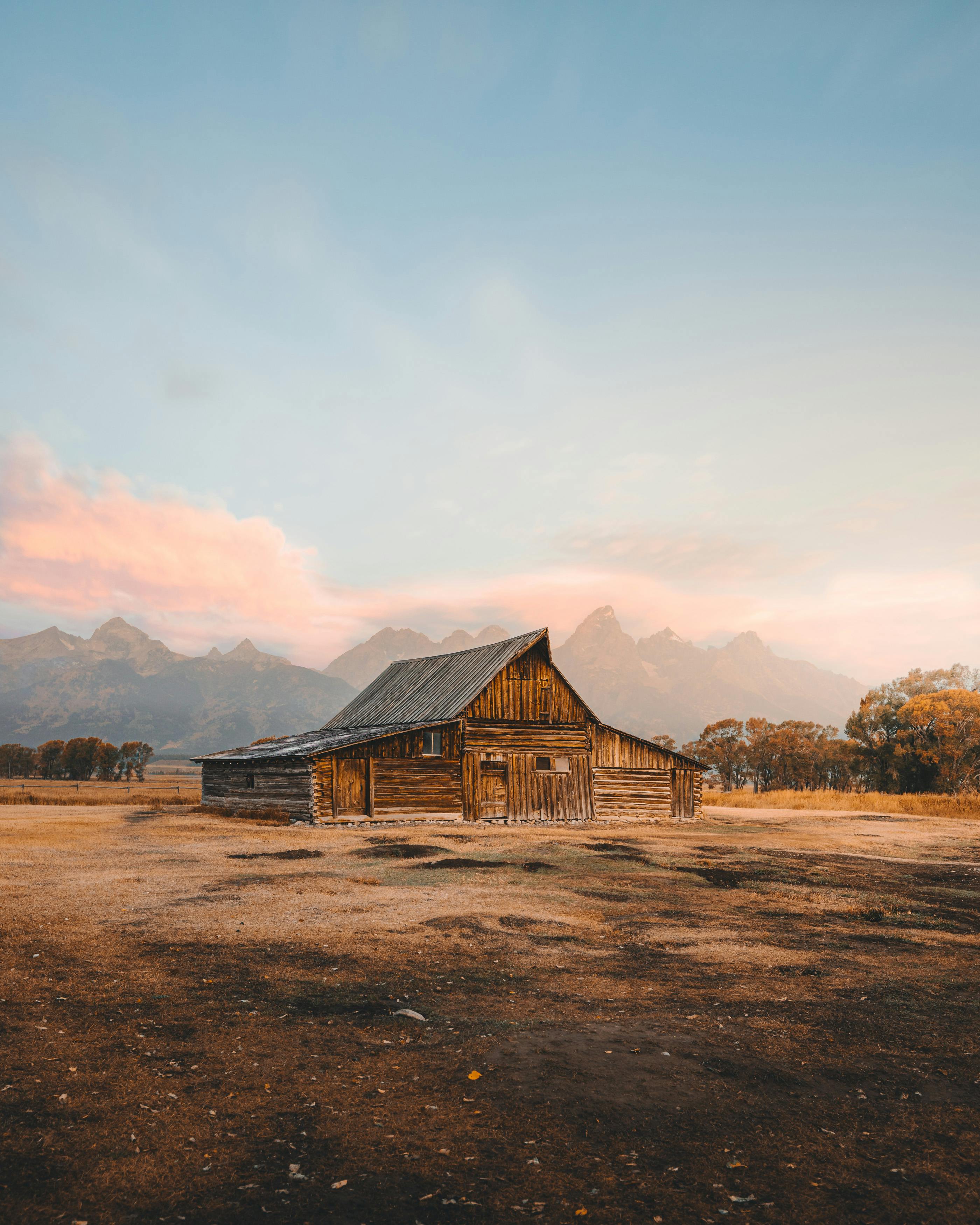 Old Barn with Mountains in Background Free Stock Photo