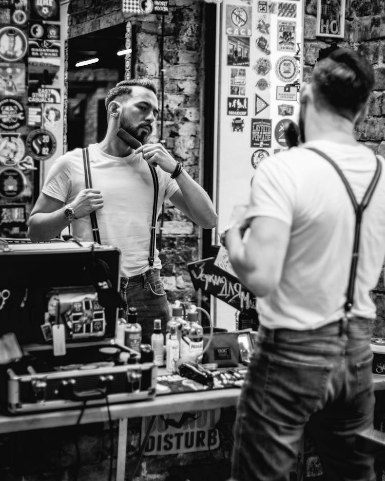 A Man Brushing His Beard