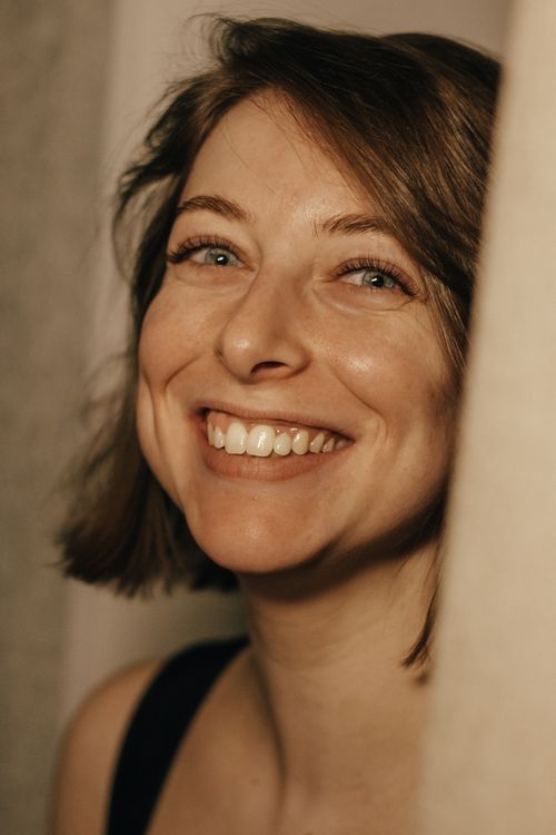 Free A cheerful, close-up portrait of a woman with a warm smile and natural lighting. Stock Photo
