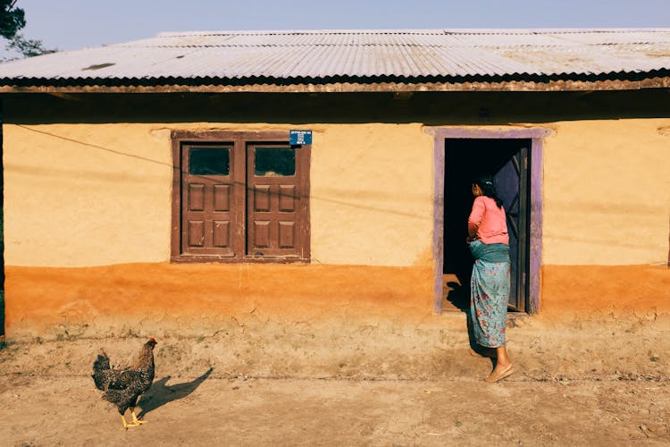 A Woman Entering A House