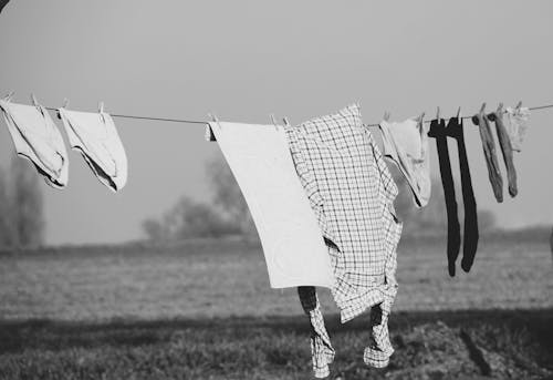 Grayscale Photo of Clothes on Clothes Line