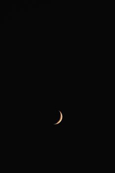 Capture the beauty of a crescent moon set against a dark night in France. Ideal for celestial enthusiasts.