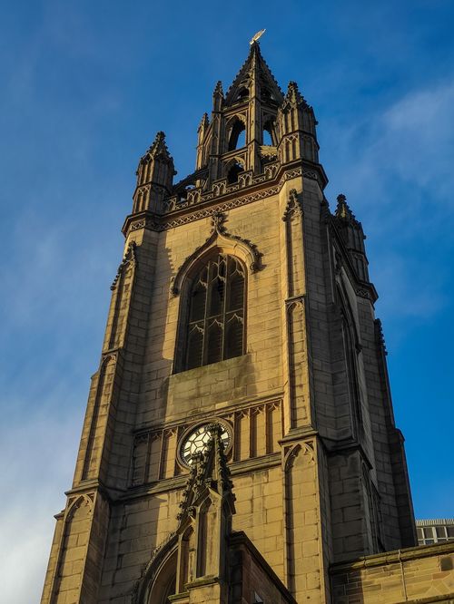 Free Low-angle view of St. Nicholas Cathedral's gothic architecture against a clear blue sky. Stock Photo