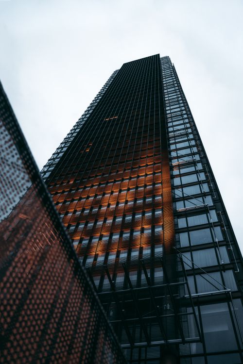 Free Low angle view of a modern skyscraper in London, showcasing its glass facade and urban architecture. Stock Photo