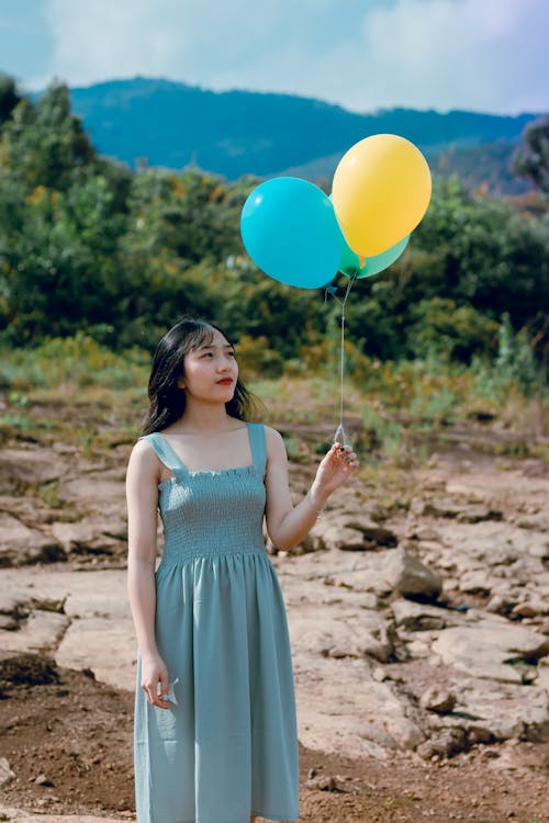 Free Photography of a Woman Holding Balloons Stock Photo