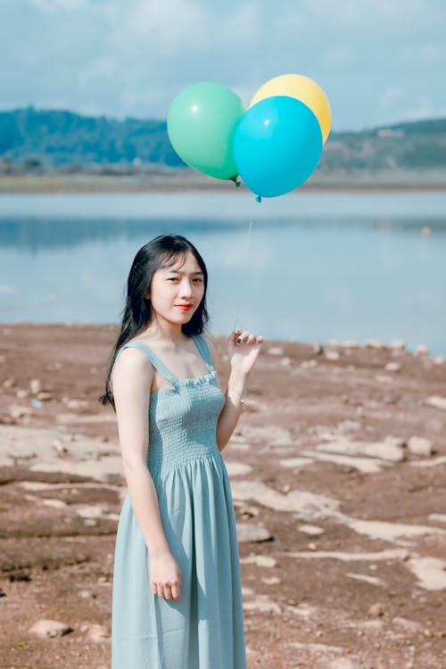 Photography of a Woman Holding Balloons