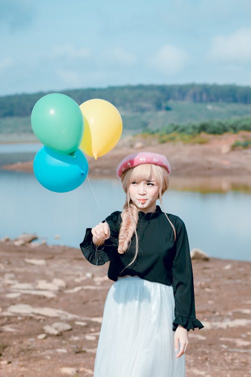 Girl In Black Top Holding Balloons