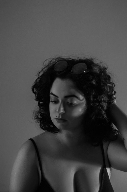 Free Elegant black and white portrait capturing a woman in a pensive pose. Stock Photo