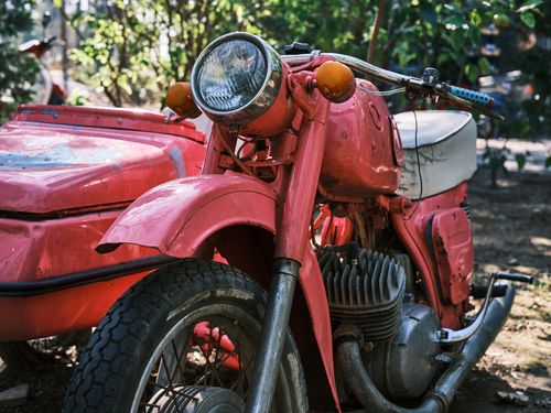 Free Classic red motorcycle with sidecar, showcasing vintage style and charm. Stock Photo
